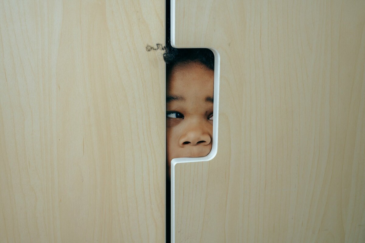 Sneak Peek Little girl sneak peaking through a wall